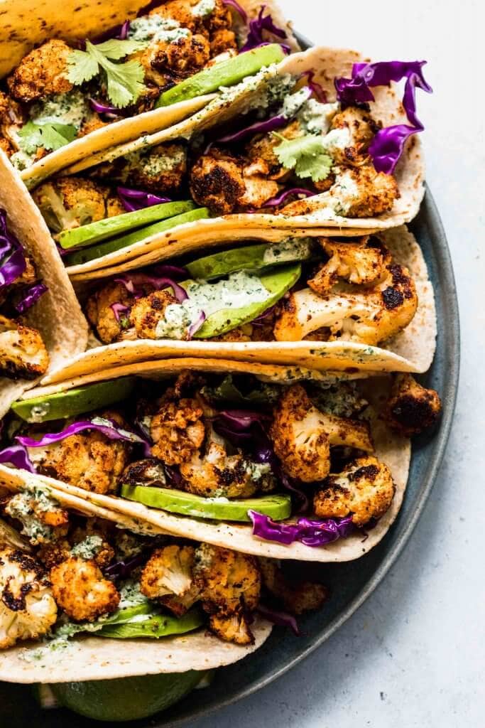 Cauliflower tacos arranged on plate. 